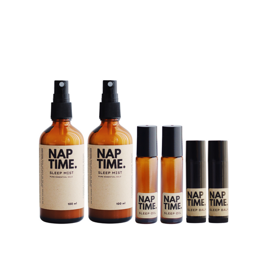 The image features Australias Best all natural sleep solution products.  It includes two 100 ml bottles of sleep mist with spray nozzles, two smaller roller ball applicators containing sleep oil.  Also featured are two sleep balm sticks, all products are labelled with a minimalism design, containing pure essential oils designed to promote better sleep. 