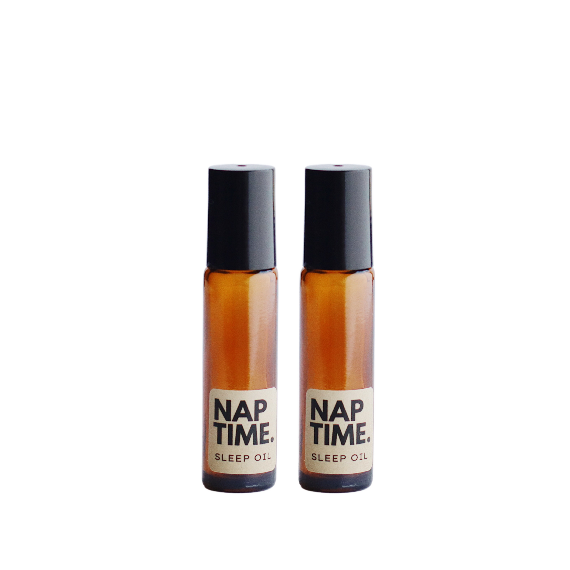 The image displays two identical bottles of a product labelled “Nap Time Sleep Oil.” The bottles have a simple clean design with transparent Amber Glass and black caps. The labels are minimalist with beige background and black text clearly indicating the product name and its purpose. The oil inside appears to be golden colour visible through the glass, which suggests a natural ingredient commonly associated with sleep aids or relaxation products. The overall aesthetic is modern and therapeutic