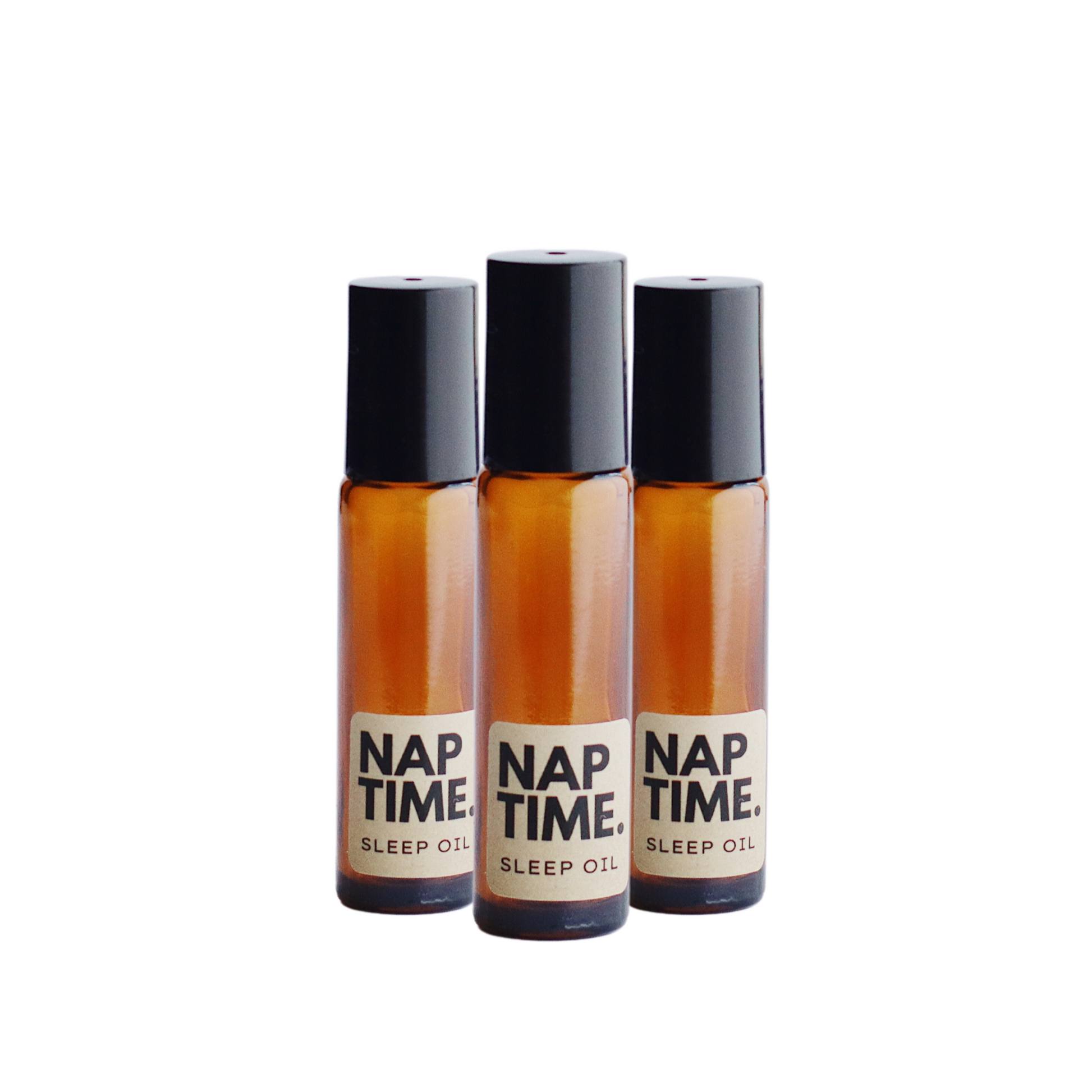 The image displays three identical bottles of a product labelled “Nap Time Sleep Oil.” The bottles have a simple clean design with transparent Amber Glass and black caps. The labels are minimalist with beige background and black text clearly indicating the product name and its purpose. The oil inside appears to be golden colour visible through the glass, which suggests a natural ingredient commonly associated with sleep aids or relaxation products.